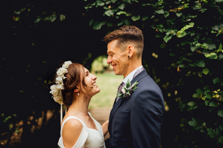 bride and groom smiling at each other