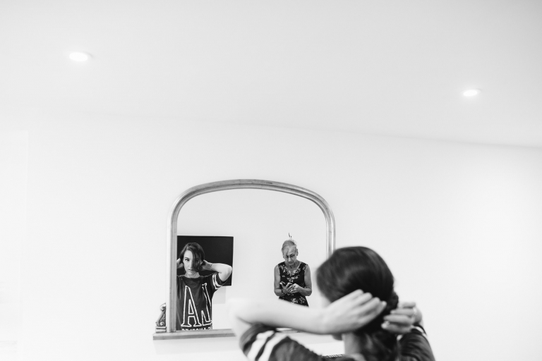 bride getting ready looking into the mirror