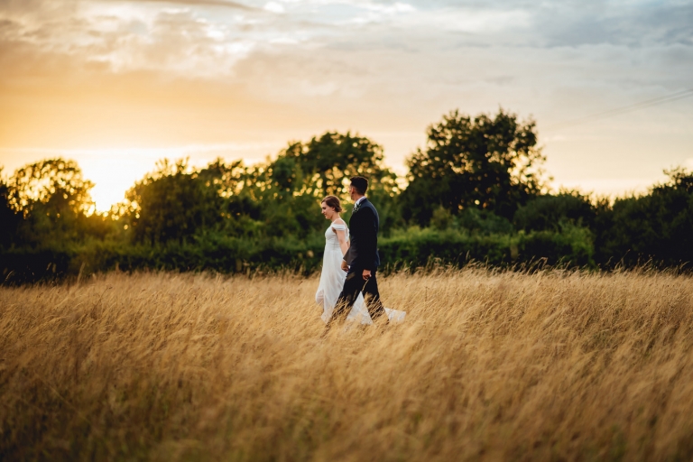 bride and groom in wheatfield